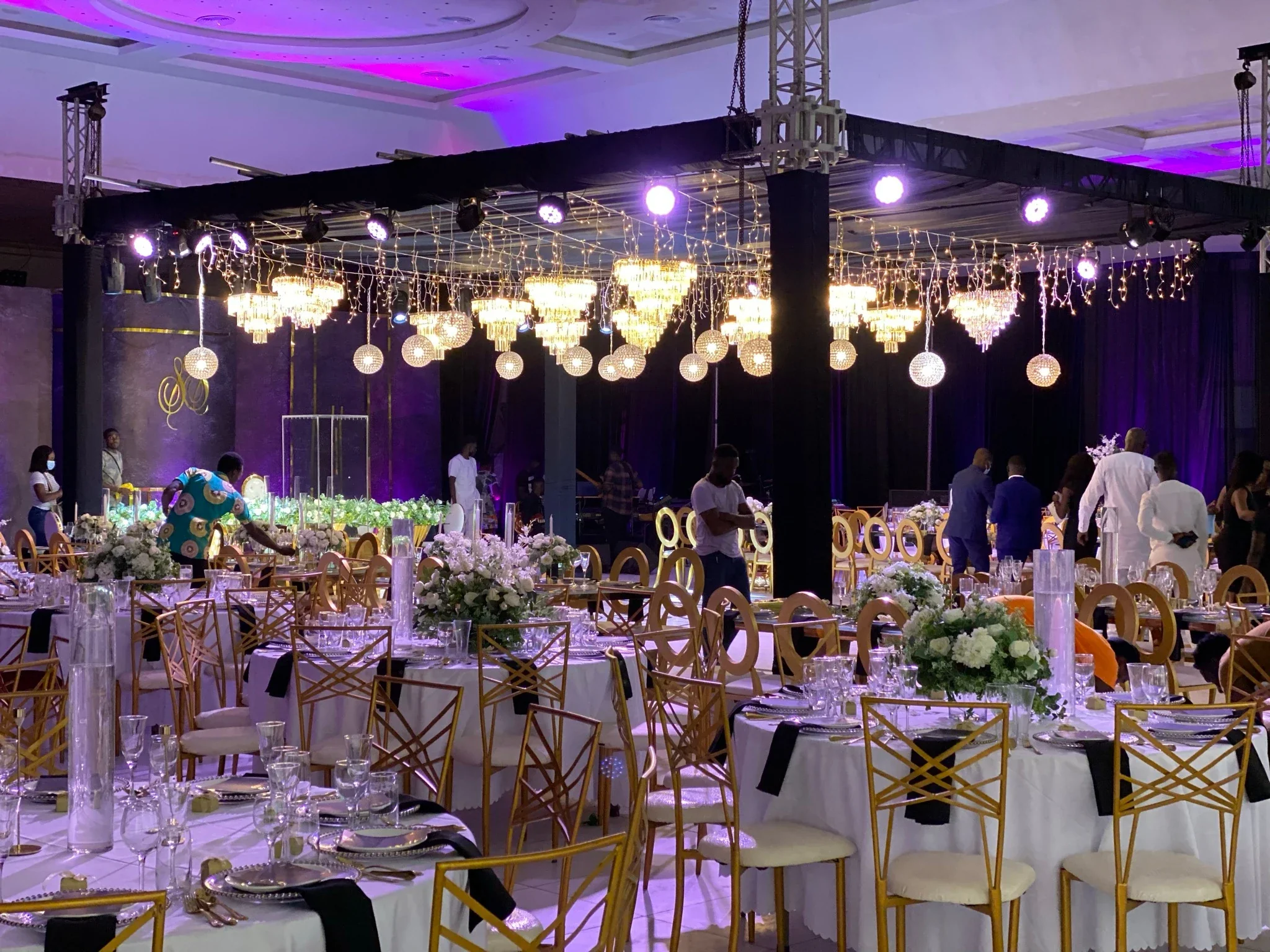 The Main Hall being prepared with tables and floral decorations for a reception