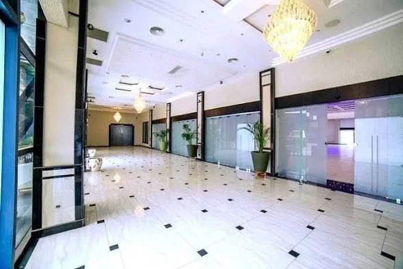 A De Icon arrival area with chandeliers and reflective flooring